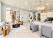 Thumbnail 13 of 53 - Leasing office lobby with reception desk and chandelier at The Barton Apartments, Dallas, TX 75206