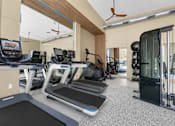 Thumbnail 26 of 53 - Fitness center with treadmills and weight machines at The Barton Apartments, Dallas