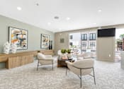 Thumbnail 20 of 53 - Community lounge with natural wood credenza and seating at The Barton Apartments, Texas, 75206