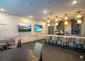 Thumbnail 39 of 39 - A modern dining area with a bar and chairs.