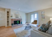 Thumbnail 2 of 57 - a living room with a fireplace and a sliding glass door at Indian Creek Apartments, Carrollton