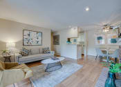 Thumbnail 1 of 57 - a living room with a couch and a table at Indian Creek Apartments, Carrollton, Texas