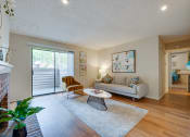 Thumbnail 4 of 57 - a living room with a couch and a chair and a sliding glass door at Indian Creek Apartments, Carrollton, TX, 75007
