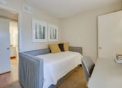 Thumbnail 10 of 57 - a bedroom with a bed and a desk at Indian Creek Apartments, Texas
