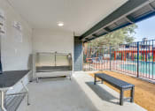 Thumbnail 24 of 57 - the retreat at thousand oaks apartment patio with swing bench and pool at Indian Creek Apartments, Carrollton, TX