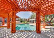 Thumbnail 32 of 57 - a backyard with a pool and a wooden pergola at Indian Creek Apartments, Texas