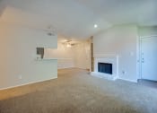 Thumbnail 51 of 57 - the living room of an empty house with a fireplace at Indian Creek Apartments, Carrollton