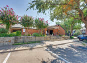 Thumbnail 45 of 57 - a brick building with trees and a sidewalk in front of it at Indian Creek Apartments, Texas