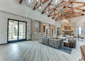 Thumbnail 51 of 68 - A spacious room with a stone wall and a wooden ceiling at Limestone Ranch Apartments, Lewisville, TX, 75067