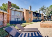 Thumbnail 12 of 32 - our apartments offer a courtyard with tables and chairs at The Manhattan Apartments, Dallas, Texas