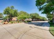 Thumbnail 32 of 32 - an empty street with houses and trees on the side of the road