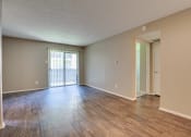 Thumbnail 2 of 32 - Room with wooden floor at The Manhattan Apartments, Dallas, 75252