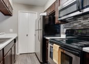 Thumbnail 1 of 32 - a kitchen with a sink and a refrigerator at The Manhattan Apartments, Dallas, Texas