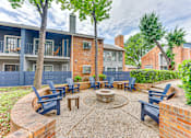 Thumbnail 31 of 51 - A patio with a fire pit and chairs. at The Manhattan Apartments, Dallas, TX