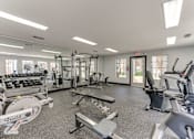 Thumbnail 30 of 51 - A gym with a variety of equipment including treadmills, weights, and exercise machines. at The Manhattan Apartments, Dallas