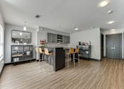 Thumbnail 45 of 51 - A modern kitchen with wooden floors and a central island. at The Manhattan Apartments, Dallas, TX