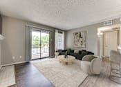 Thumbnail 11 of 51 - A living room with a fireplace and a couch. at The Manhattan Apartments, Dallas, TX, 75252