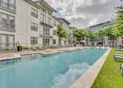 Thumbnail 39 of 52 - Outdoor swimming pool surrounded by apartment buildings at The Montrose Apartments, Texas, 75204