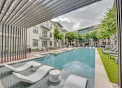 Thumbnail 33 of 52 - Swimming pool with tanning ledge and pergola at The Montrose Apartments, Dallas, TX 75204