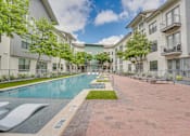 Thumbnail 34 of 52 - Courtyard pool area with paver deck at The Montrose Apartments, Dallas