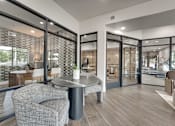 Thumbnail 22 of 52 - Modern clubhouse lounge with glass walls at The Montrose Apartments, Dallas, TX