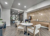 Thumbnail 30 of 52 - Community cafe with seating and kitchenette at The Montrose Apartments, Dallas