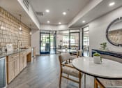 Thumbnail 27 of 52 - Clubhouse kitchen with dining area and lounge access at The Montrose Apartments, Texas, 75204