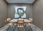 Thumbnail 25 of 52 - Dining area with modern chairs and abstract artwork at The Montrose Apartments, Dallas, 75204