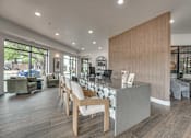 Thumbnail 20 of 52 - Contemporary workspace with vertical wood slat accent wall at The Montrose Apartments, Dallas, TX 75204