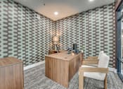 Thumbnail 17 of 52 - Leasing office desk with patterned accent wall at The Montrose Apartments, Dallas, TX