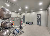 Thumbnail 48 of 52 - Fitness center with exercise equipment and mirrored walls at The Montrose Apartments, Dallas