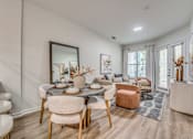 Thumbnail 5 of 52 - Open concept dining and living room with modern furnishings at The Montrose Apartments, Texas