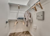 Thumbnail 12 of 52 - Walk-in closet with hanging rods and shelving at The Montrose Apartments, Dallas, TX
