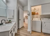 Thumbnail 13 of 52 - Laundry room with washer and dryer in closet at The Montrose Apartments, Dallas, Texas