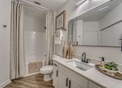 Thumbnail 11 of 52 - Modern bathroom with white vanity and undermount sink at The Montrose Apartments, Texas