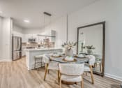 Thumbnail 1 of 52 - Open concept kitchen and dining area with island seating at The Montrose Apartments, Dallas, 75204