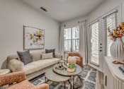 Thumbnail 7 of 52 - Cozy living room with beige sofa and armchairs at The Montrose Apartments, Dallas, Texas