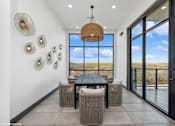 Thumbnail 18 of 29 - A modern dining room with a view of the outdoors.