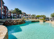 Thumbnail 16 of 41 - a large pool with a building in the background  at Paces Crossing, Denton