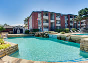 Thumbnail 17 of 41 - a swimming pool with an apartment building in the background  at Paces Crossing, Denton, 76210