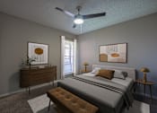 Thumbnail 6 of 41 - A bedroom with a bed, nightstand, and a ceiling fan.
