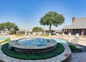 Thumbnail 24 of 41 - an outdoor pool with a fountain and a building in the background at Paces Crossing, Texas