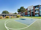 Thumbnail 29 of 41 - a basketball court in front of an apartment building at Paces Crossing, Denton, TX
