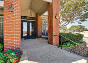 Thumbnail 39 of 41 - the entrance to a brick building with a glass door at Paces Crossing, Denton, TX