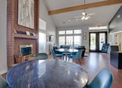 Thumbnail 35 of 41 - a dining room with a table and chairs and a fireplace at Paces Crossing, Denton, Texas