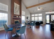Thumbnail 34 of 41 - a living room with a table and chairs and a brick fireplace at Paces Crossing, Denton, Texas