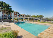 Thumbnail 20 of 41 - our apartments offer a swimming pool with a gazebo and chairs at Paces Crossing, Texas