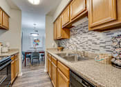 Thumbnail 13 of 72 - kitchen with wooden cabinets at Southern Oaks, Fort Worth, 76132