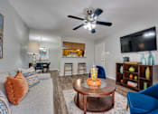 Thumbnail 2 of 72 - coffee table, and a flat screen TV mounted on the wall at Southern Oaks, Fort Worth, TX