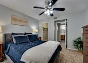 Thumbnail 15 of 72 - Bedroom with blue bed and fan at Southern Oaks, Fort Worth  